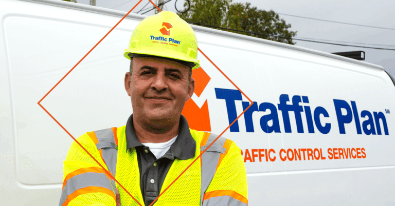 traffic plan employee agron standing in front of white company van while wearing neon hat