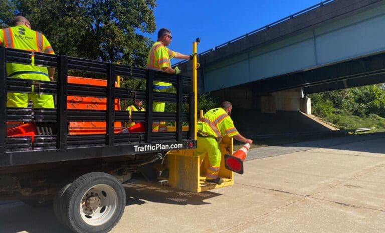 road flaggers in the back of a truck